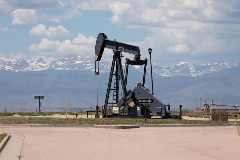 An oil pump jack is pictured in the middle of a traffic circle at a new residential development in Weld County on June 24, 2020. (Andy Bosselman for Colorado Newsline)