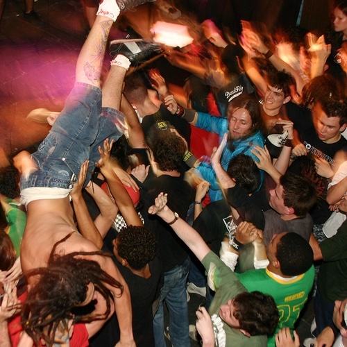 crowd surfing over the mosh pit